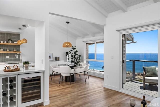21659 Ocean Vista Dr Unit 20, Laguna Beach, CA 92651 - indoor wet bar with wine cooler, a water view, light wood-style floors, decorative light fixtures, and wooden ceiling