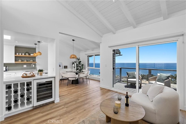 21659 Ocean Vista Dr Unit 20, Laguna Beach, CA 92651 - living area featuring wine cooler, bar with sink, light wood-style floors, a water view, and beam ceiling