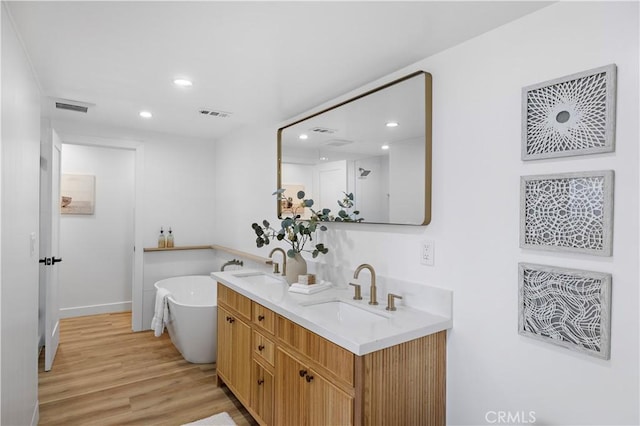 21659 Ocean Vista Dr Unit 20, Laguna Beach, CA 92651 - full bathroom featuring recessed lighting, a freestanding bath, double vanity, and wood finished floors