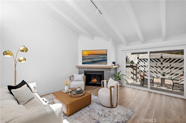 21659 Ocean Vista Dr Unit 20, Laguna Beach, CA 92651 - living room with a brick fireplace, wood finished floors, a wooden ceiling with exposed beams, high vaulted ceiling, and rail lighting