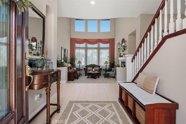 2841 Dos Lomas Pl, Fallbrook, CA 92028 - foyer entrance with light tile patterned flooring, a towering ceiling, and stairway