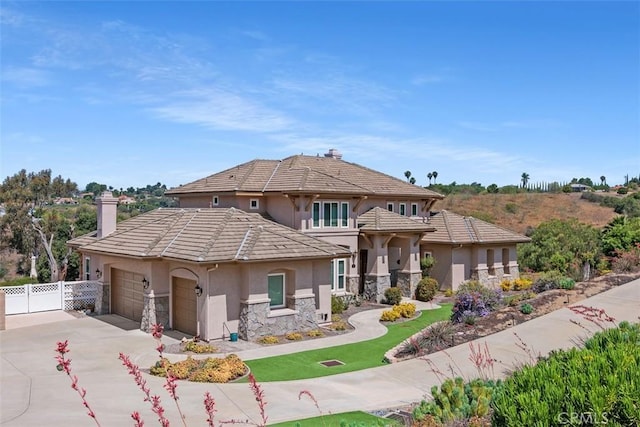 2841 Dos Lomas Pl, Fallbrook, CA 92028 - view of front of house featuring stucco siding, an attached garage, stone siding, a chimney, and concrete driveway