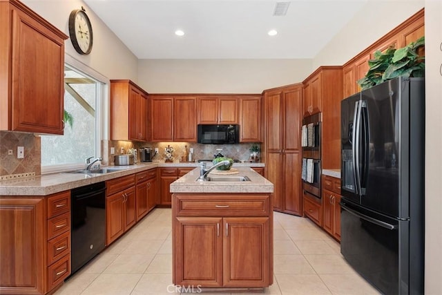 2841 Dos Lomas Pl, Fallbrook, CA 92028 - kitchen featuring black appliances, a kitchen island with sink, light countertops, brown cabinetry, and recessed lighting