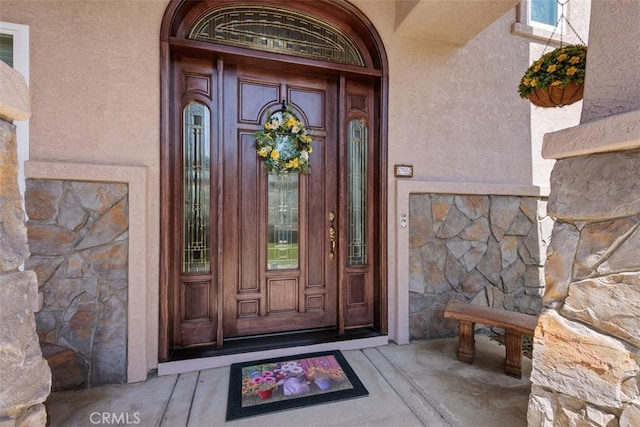 2841 Dos Lomas Pl, Fallbrook, CA 92028 - view of exterior entry with stone siding, stucco siding, and a porch