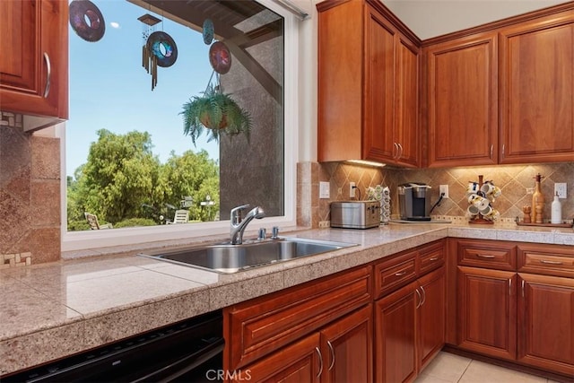 2841 Dos Lomas Pl, Fallbrook, CA 92028 - kitchen featuring dishwashing machine, backsplash, brown cabinets, and light tile patterned floors