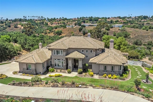 2841 Dos Lomas Pl, Fallbrook, CA 92028 - view of front of home with stucco siding, a chimney, a tile roof, a front yard, and stone siding