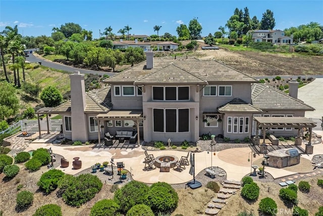 2841 Dos Lomas Pl, Fallbrook, CA 92028 - back of property with a fire pit, a pergola, a chimney, and a patio