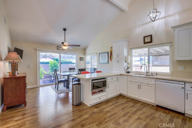 13418 Palm Pl, Cerritos, CA 90703 - kitchen featuring dishwasher, stainless steel microwave, ceiling fan, a peninsula, and beamed ceiling