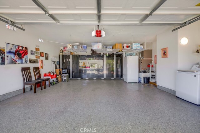 13418 Palm Pl, Cerritos, CA 90703 - garage featuring washer / dryer and a garage door opener