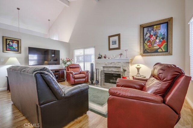 13418 Palm Pl, Cerritos, CA 90703 - living room featuring a fireplace, light wood-style floors, beam ceiling, and high vaulted ceiling