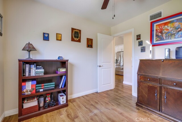13418 Palm Pl, Cerritos, CA 90703 - bedroom with stainless steel refrigerator with ice dispenser, wood finished floors, and a ceiling fan
