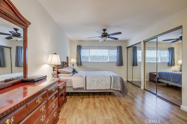 13418 Palm Pl, Cerritos, CA 90703 - bedroom with multiple closets, light wood-style floors, and ceiling fan