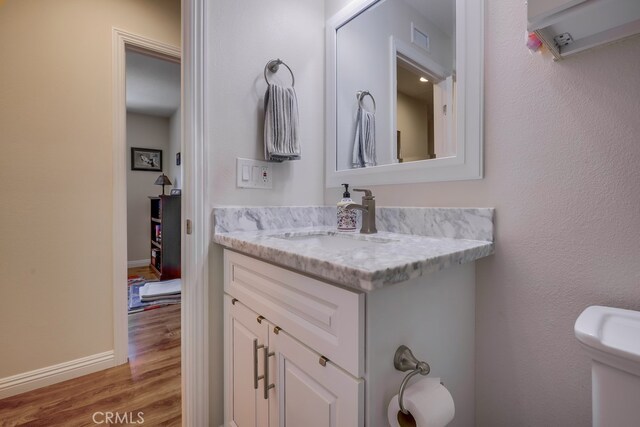 13418 Palm Pl, Cerritos, CA 90703 - bathroom with wood finished floors and vanity