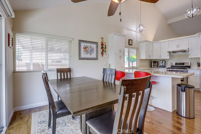 13418 Palm Pl, Cerritos, CA 90703 - dining room with light wood-style flooring, ceiling fan, and high vaulted ceiling