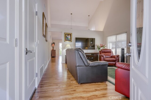 13418 Palm Pl, Cerritos, CA 90703 - living room featuring light wood finished floors and a high ceiling
