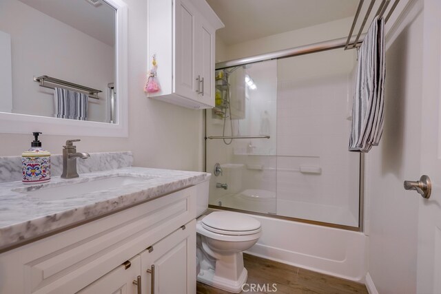 13418 Palm Pl, Cerritos, CA 90703 - full bath with vanity, bath / shower combo with glass door, and wood finished floors