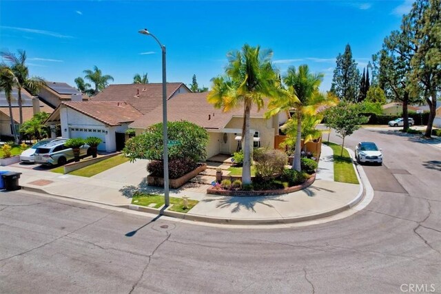 13418 Palm Pl, Cerritos, CA 90703 - view of front of property featuring a garage, concrete driveway, and stucco siding
