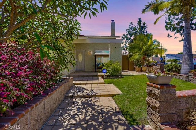 13418 Palm Pl, Cerritos, CA 90703 - view of front of property featuring stucco siding, a chimney, and a front yard