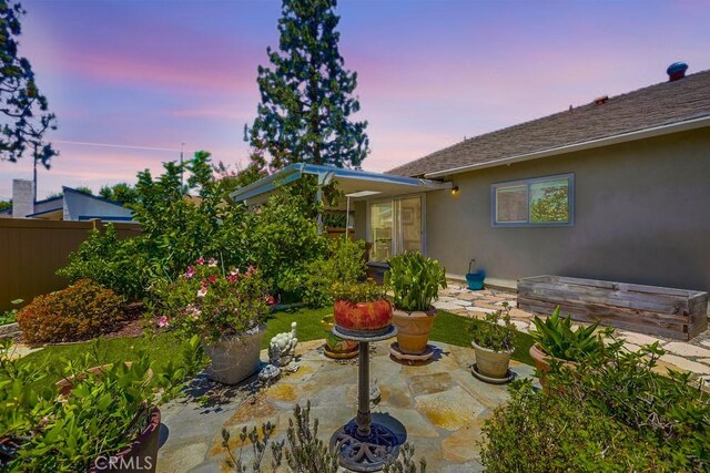 13418 Palm Pl, Cerritos, CA 90703 - yard at dusk with a patio