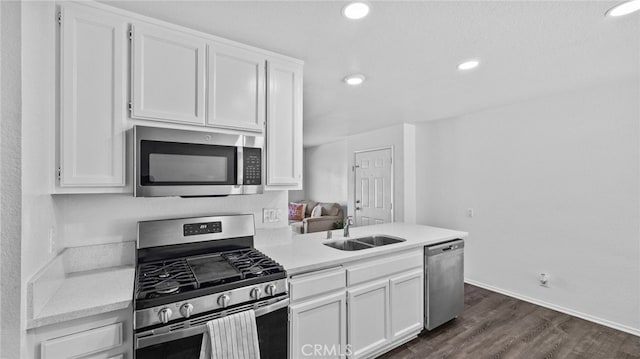 1365 Crafton Ave Unit 1004, Mentone, CA 92359 - kitchen featuring appliances with stainless steel finishes, white cabinets, light countertops, dark wood finished floors, and recessed lighting