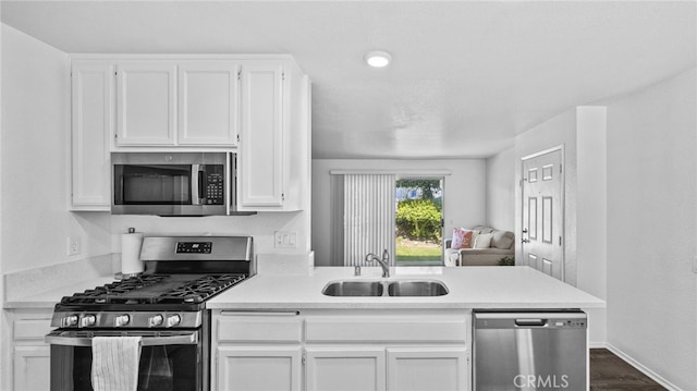 1365 Crafton Ave Unit 1004, Mentone, CA 92359 - kitchen featuring appliances with stainless steel finishes, white cabinetry, light countertops, and a peninsula