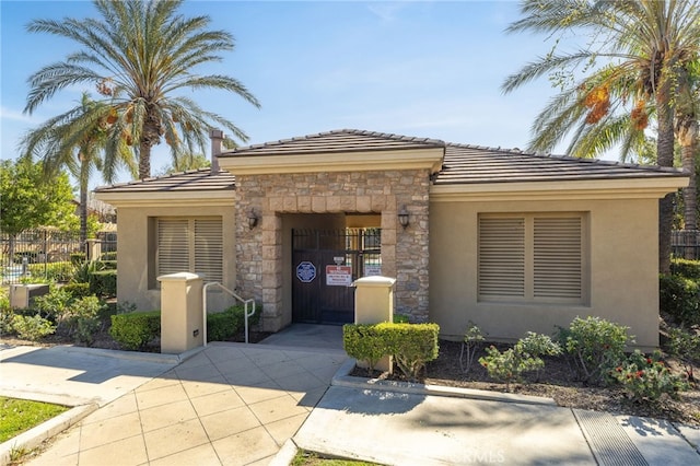 544 W Elm Park Ave, Rialto, CA 92376 - prairie-style house with stone siding, stucco siding, and a tile roof