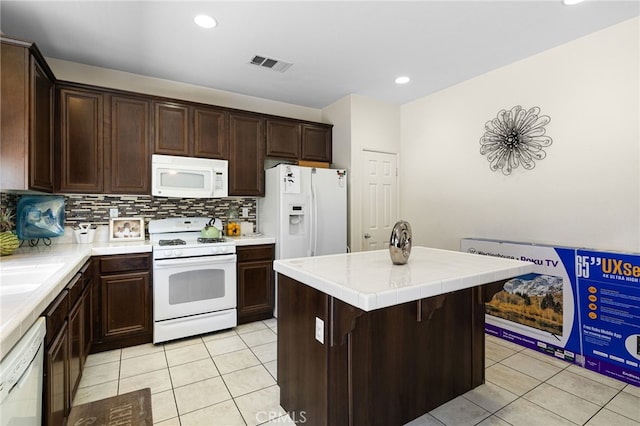 544 W Elm Park Ave, Rialto, CA 92376 - kitchen featuring white appliances, light tile patterned flooring, tile counters, dark brown cabinetry, and tasteful backsplash