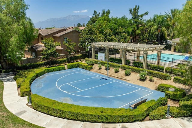 544 W Elm Park Ave, Rialto, CA 92376 - view of basketball court with a pergola, a mountain view, and a community pool