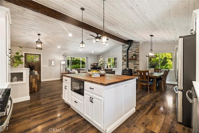 15320 Forest Ranch Way, Forest Ranch, CA 95942 - kitchen with butcher block counters, stainless steel appliances, a wood stove, dark wood finished floors, and wooden ceiling