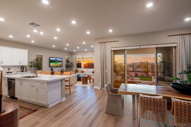 660 Westbrook Loop, San Marcos, CA 92078 - kitchen featuring open floor plan, light wood-style floors, white cabinets, a kitchen island with sink, and light countertops
