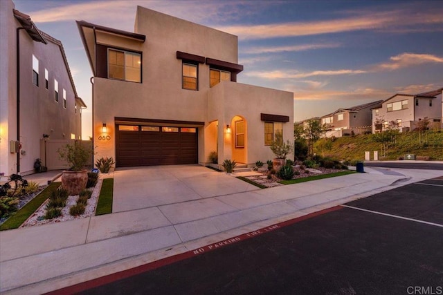 660 Westbrook Loop, San Marcos, CA 92078 - view of front of house with stucco siding, driveway, a garage, and a residential view