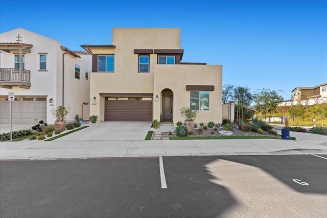 660 Westbrook Loop, San Marcos, CA 92078 - view of front facade with stucco siding, an attached garage, and driveway