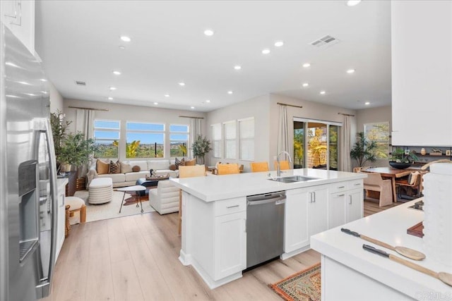 660 Westbrook Loop, San Marcos, CA 92078 - kitchen featuring stainless steel appliances, recessed lighting, an island with sink, light wood-style flooring, and white cabinetry