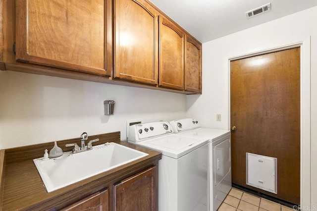 2239 Sunset Dr, Escondido, CA 92025 - washroom with washer and clothes dryer, cabinet space, and light tile patterned floors
