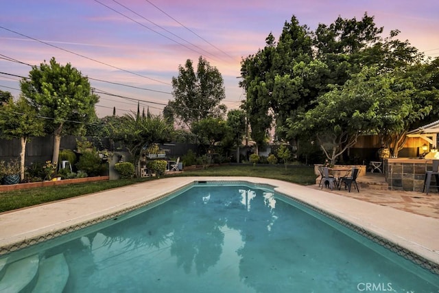 7951 Woodlake Ave, West Hills, CA 91304 - pool at dusk with a patio area and a fenced backyard