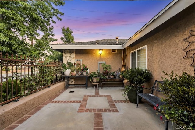 7951 Woodlake Ave, West Hills, CA 91304 - patio terrace at dusk with a patio