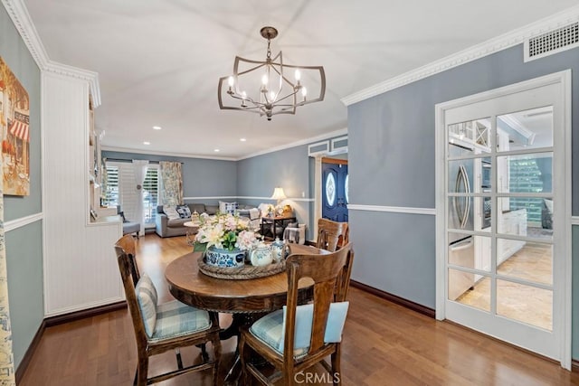 7951 Woodlake Ave, West Hills, CA 91304 - dining room featuring wood finished floors, a chandelier, and crown molding