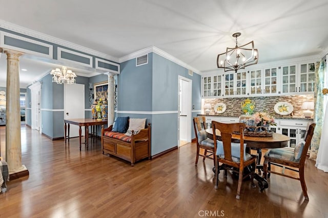 7951 Woodlake Ave, West Hills, CA 91304 - dining room featuring decorative columns, a chandelier, wood finished floors, and crown molding