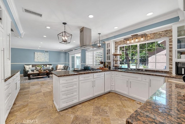 7951 Woodlake Ave, West Hills, CA 91304 - kitchen with island exhaust hood, ornamental molding, open floor plan, stone tile floors, and white cabinets