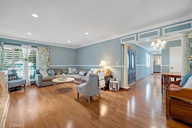 7951 Woodlake Ave, West Hills, CA 91304 - living room featuring decorative columns, crown molding, plenty of natural light, wood finished floors, and a chandelier