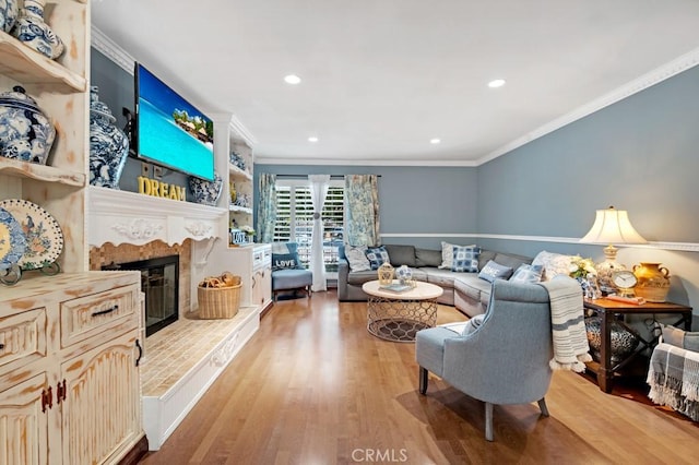7951 Woodlake Ave, West Hills, CA 91304 - living area with light wood-style floors, crown molding, recessed lighting, and a high end fireplace
