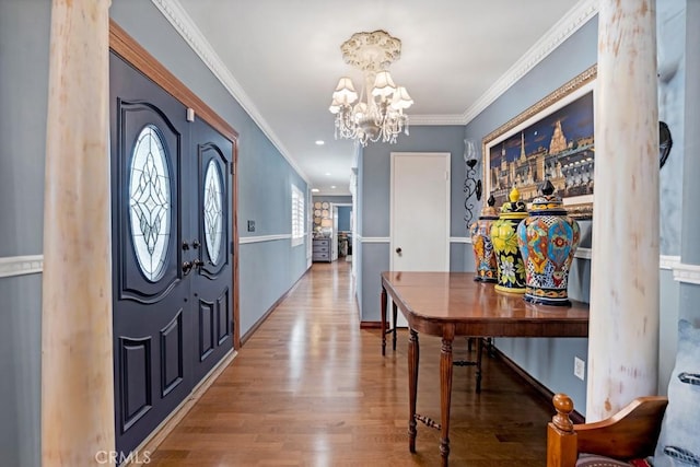 7951 Woodlake Ave, West Hills, CA 91304 - entrance foyer with wood finished floors, a chandelier, and ornamental molding
