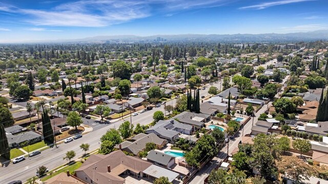 7951 Woodlake Ave, West Hills, CA 91304 - aerial view of residential area featuring a mountain backdrop and a pool area