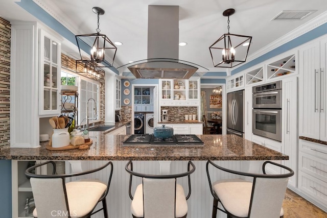 7951 Woodlake Ave, West Hills, CA 91304 - kitchen featuring a chandelier, separate washer and dryer, island exhaust hood, appliances with stainless steel finishes, and recessed lighting