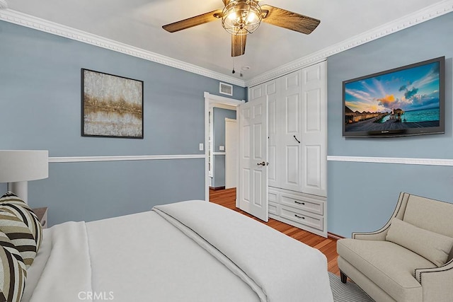 7951 Woodlake Ave, West Hills, CA 91304 - bedroom with wood finished floors, a ceiling fan, and crown molding