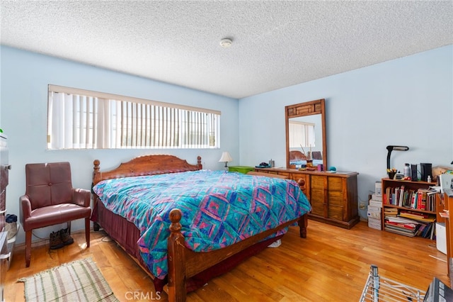 19722 Tajauta Ave, Carson, CA 90746 - bedroom featuring a textured ceiling and wood finished floors