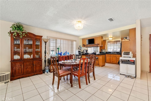 19722 Tajauta Ave, Carson, CA 90746 - dining room featuring a textured ceiling, light tile patterned floors, and a chandelier