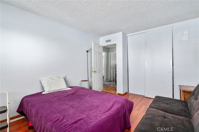 19722 Tajauta Ave, Carson, CA 90746 - bedroom with wood finished floors, a closet, and a textured ceiling