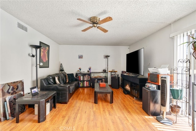 19722 Tajauta Ave, Carson, CA 90746 - living area with a ceiling fan, light wood-style flooring, and a textured ceiling