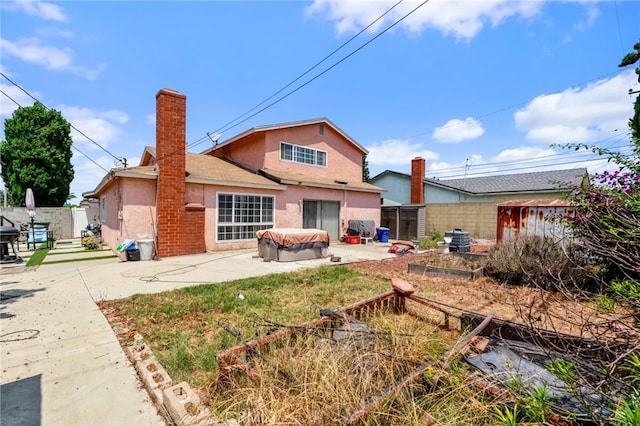 19722 Tajauta Ave, Carson, CA 90746 - back of property with stucco siding, a patio area, a fenced backyard, and a chimney